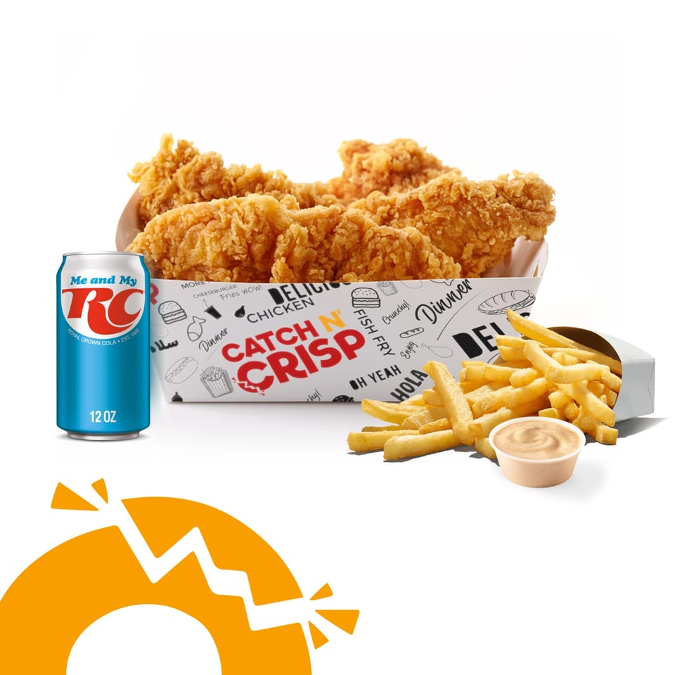 Crispy fried chicken tenders in a box, a side of fries with dipping sauce, and a blue RC Cola can.