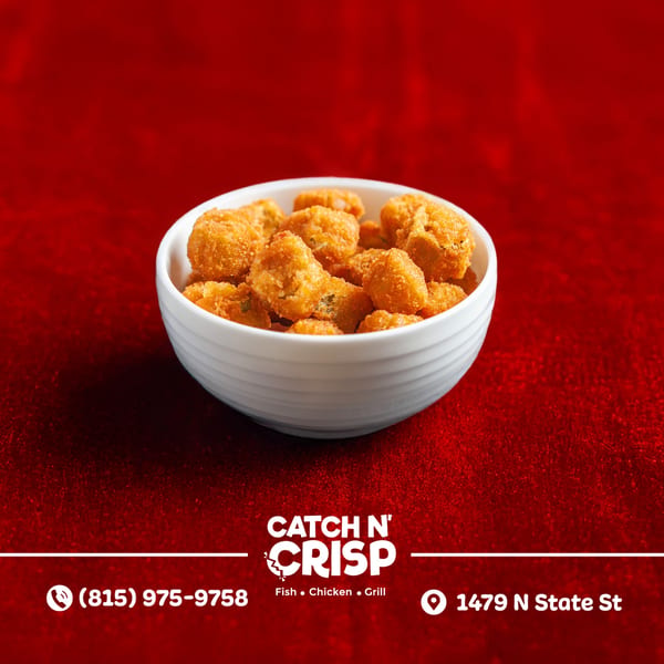 A white bowl filled with golden-brown fried chicken bites, against a vibrant red background.